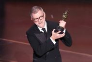 <a href='ator/3663/paul-thomas-anderson/' style='color:#FFFFFF' class='enlace_azul'>Paul Thomas Anderson</a> - Prêmios Oscar 2026 